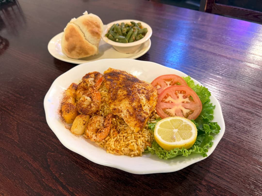 Fisherman's platter — broiled red snapper, shrimp, and scallops over rice